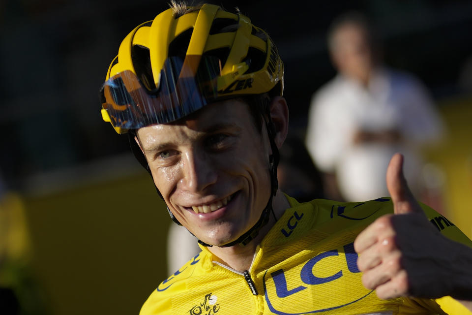 Tour de France winner Denmark's Jonas Vingegaard, wearing the overall leader's yellow jersey, flashes a thumbs up after the twenty-first stage of the Tour de France cycling race over 116 kilometers (72 miles) with start in Paris la Defense Arena and finish on the Champs Elysees in Paris, France, Sunday, July 24, 2022. (AP Photo/Thibault Camus)