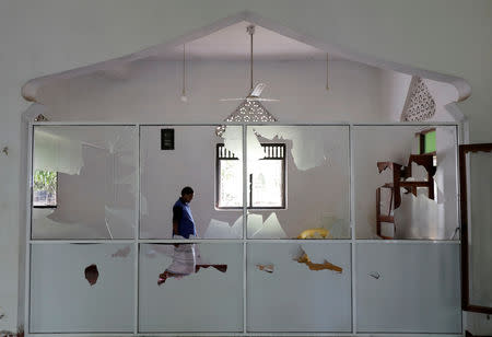 A Muslim man walks inside the Al-Masjidul Hudha mosque after a mob attack in Kottampitiya, Sri Lanka, May 14. REUTERS/Dinuka Liyanawatte