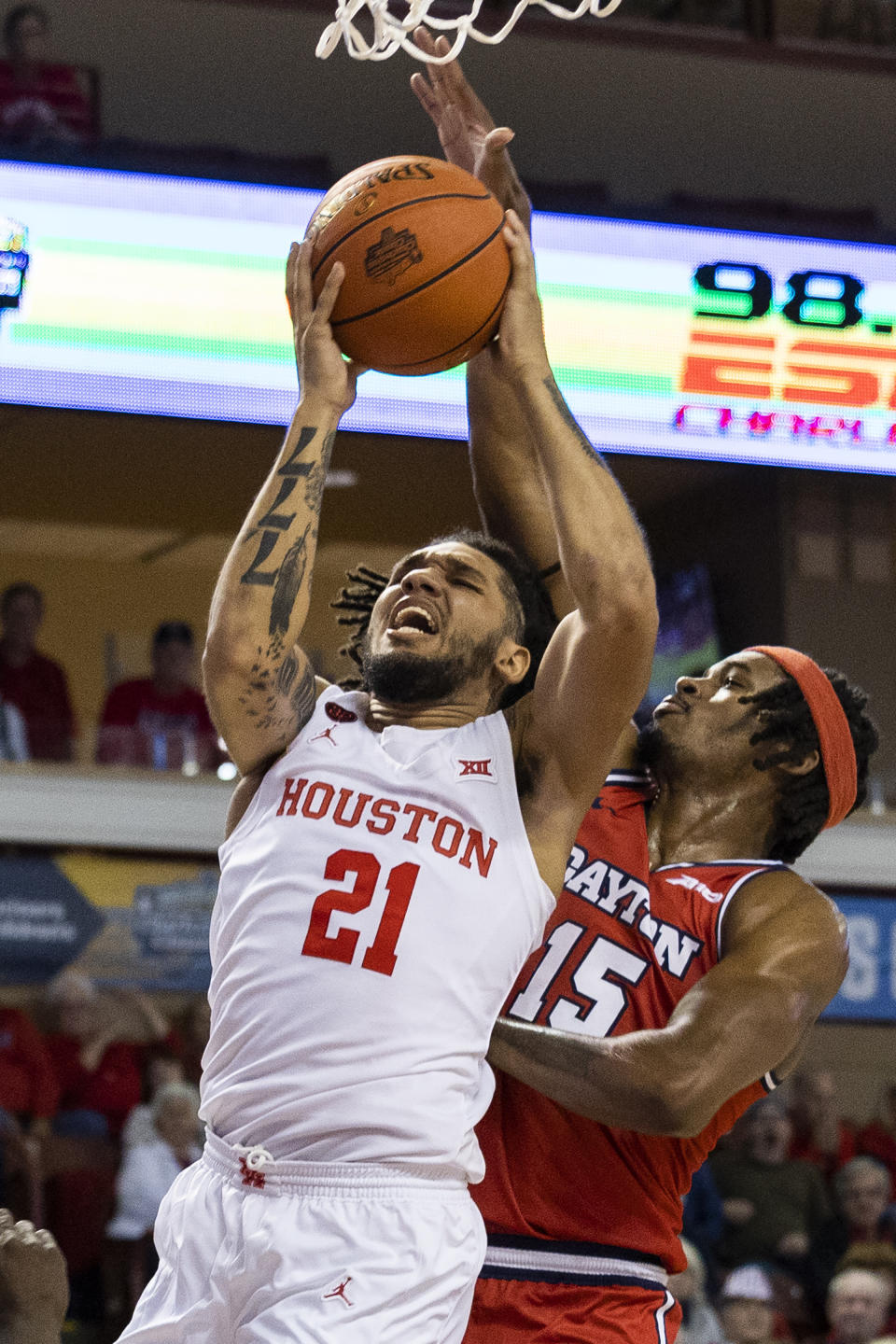 Houston's Emanuel Sharp (21) goes up for a shot against the defense of Dayton's DaRon Holmes II (15) in the first half of an NCAA college basketball game during the Charleston Classic in Charleston, S.C., Sunday, Nov. 19, 2023. (AP Photo/Mic Smith).