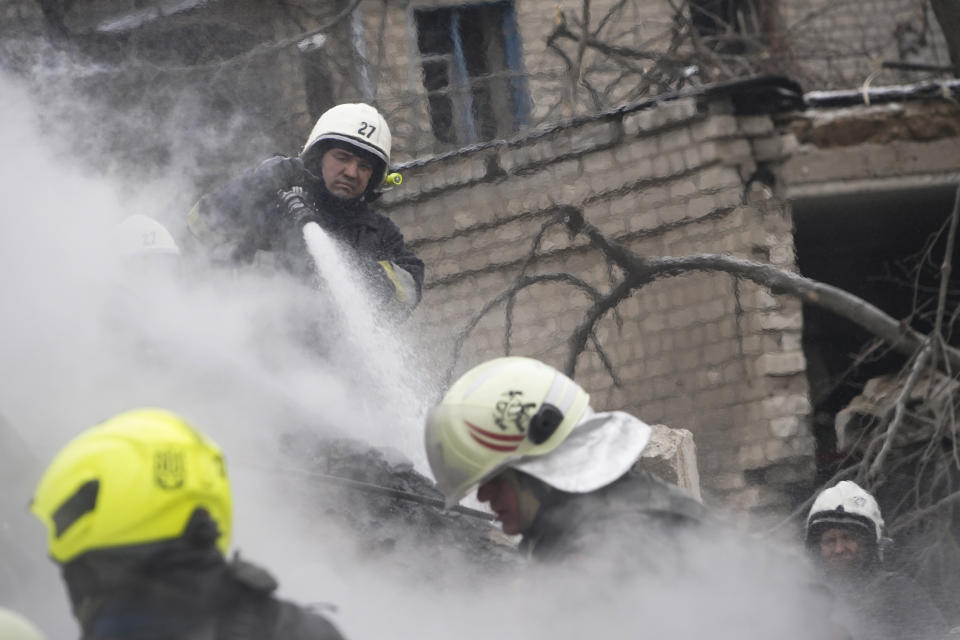 Rescuers work the scene of a building damaged by Russian rocket attack in Kharkiv, Ukraine, Tuesday, Jan. 23, 2024. (AP Photo/Andrii Marienko)