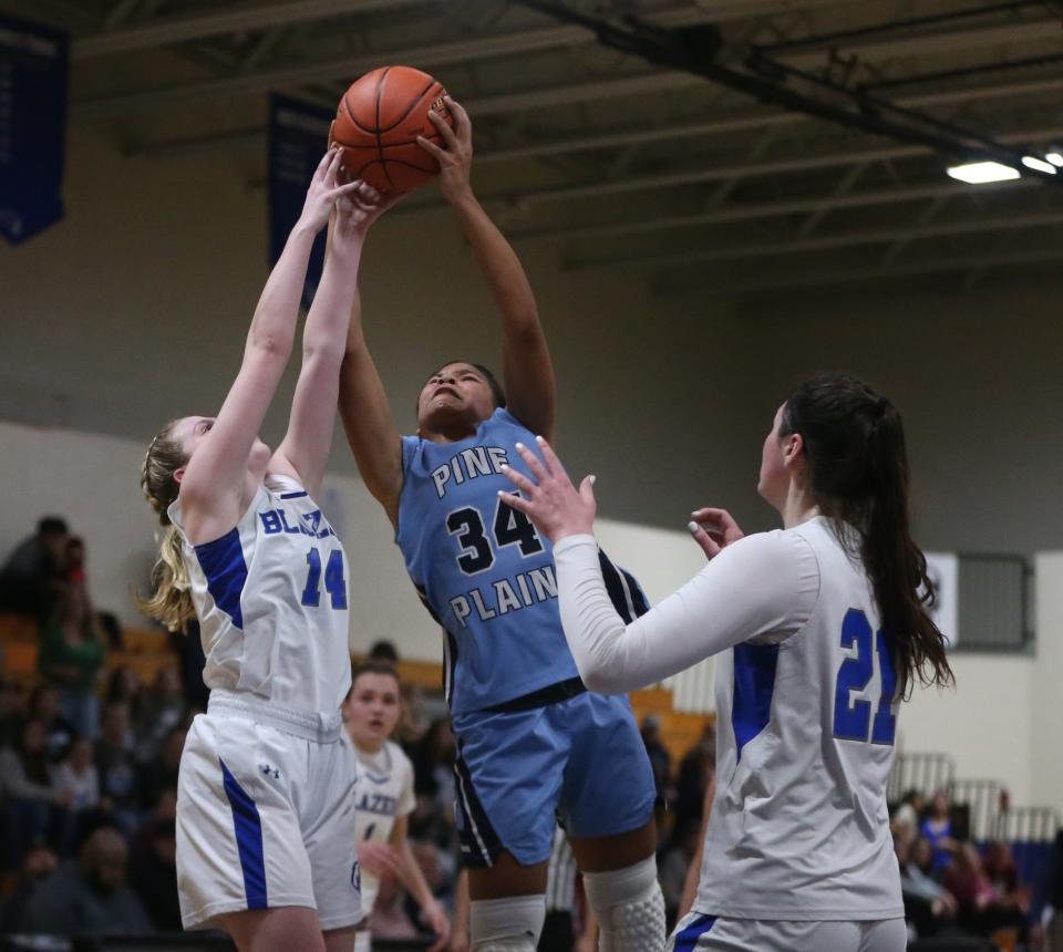 Pine Plains' Neveah Rennie goes for a rebound against Millbrook's, from left Serafina Fauci and Natalie Fox during the Section 9 Class C girls basketball championship on February 28, 2024.