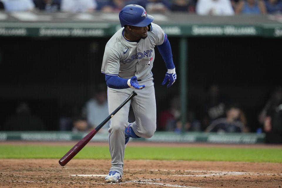 Toronto Blue Jays' Orelvis Martinez drops his bat and runs to first base with his first hit in the majors, during the sixth inning of the team's baseball game against the Cleveland Guardians, Friday, June 21, 2024, in Cleveland. (AP Photo/Sue Ogrocki)