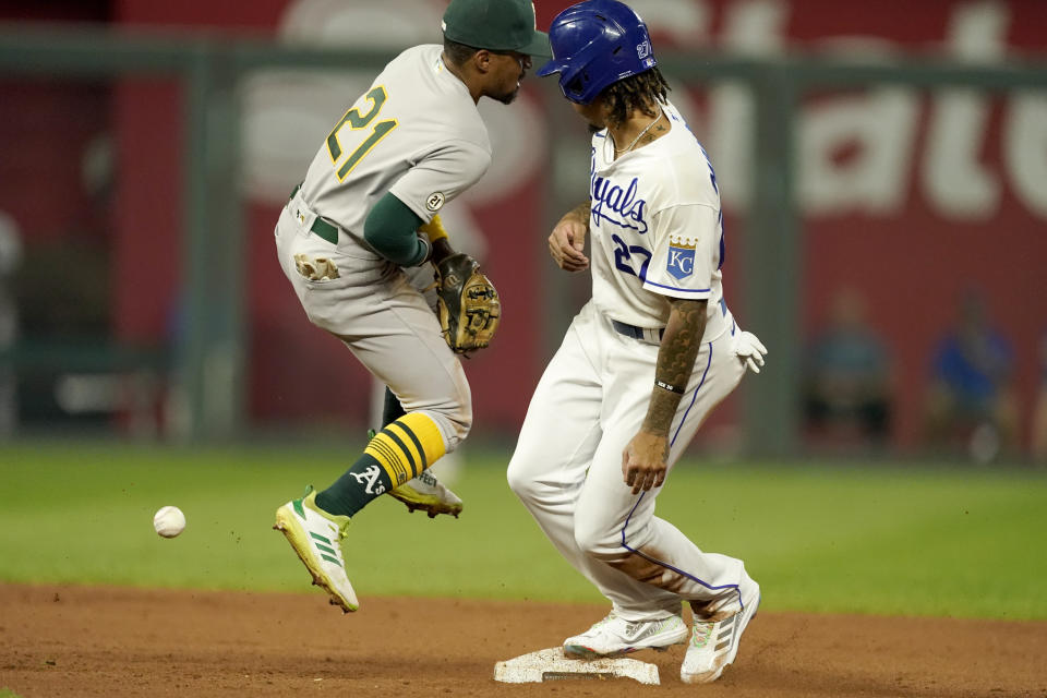 Kansas City Royals' Adalberto Mondesi (27) beats the tag by Oakland Athletics second baseman Tony Kemp (21) to steal second during the fourth inning of a baseball game Wednesday, Sept. 15, 2021, in Kansas City, Mo. (AP Photo/Charlie Riedel)