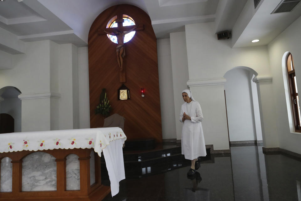 In this Aug. 27, 2019, photo, ST. Mary's School Vice Principal Sister Ana Rosa Sivori prays inside a church at the girls' school in Udon Thani, about 570 kilometers (355 miles) northeast of Bangkok, Thailand. Sister Ana Rosa Sivori, originally from Buenos Aires in Argentina, shares a great-grandfather with Jorge Mario Bergoglio, who, six years ago, became Pope Francis. So, she and the pontiff are second cousins. (AP Photo/Sakchai Lalit)