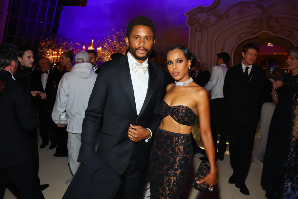 Kerry Washington and Nnamdi Asomugha at a formal event. Kerry wears a laced evening gown, and Nnamdi wears a bow-tied tuxedo. They are posing together