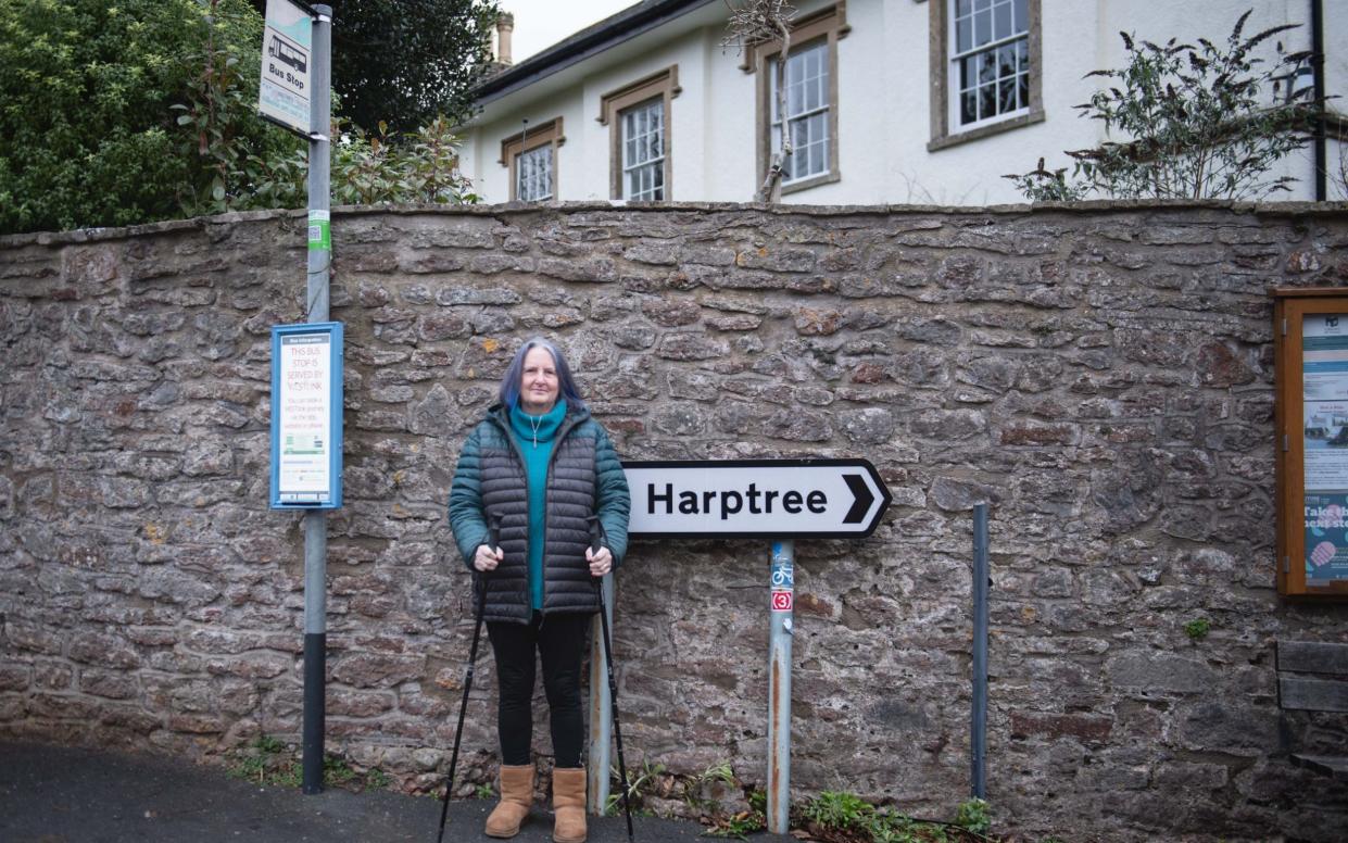 Jackie Head stands next to her local bus stop in East Harptree