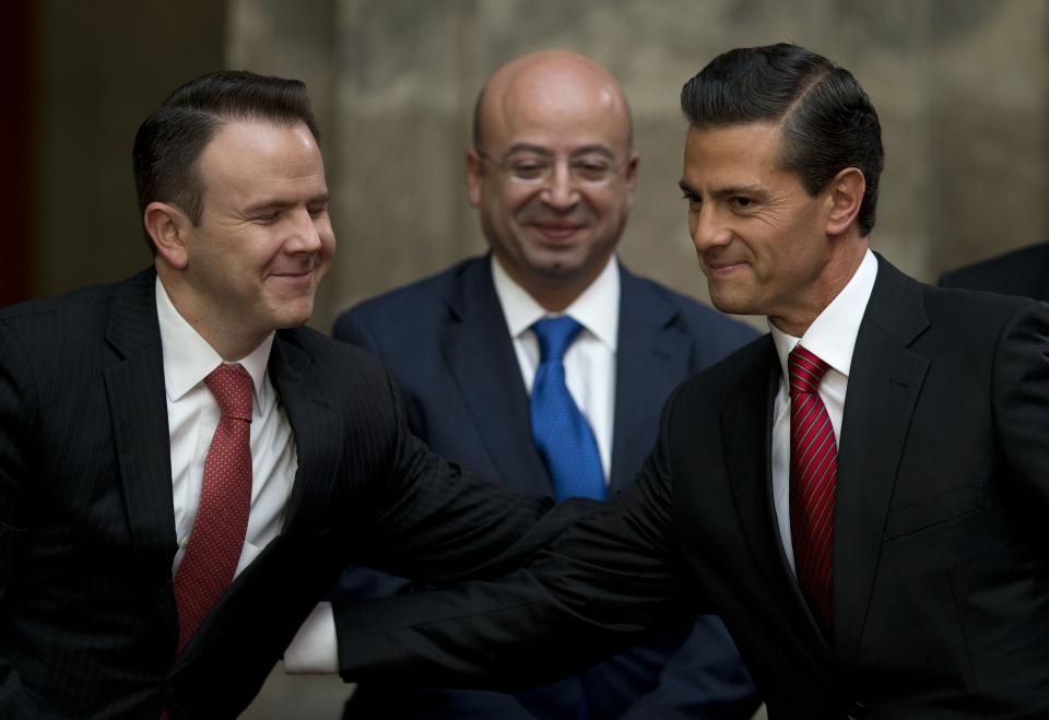 FILE - In tis Friday, Jan. 8, 2016 file photo, former Mexican President Enrique Pena Nieto, right, shakes hands with Francisco Guzman, left, head of the president's office, as National Security Commissioner Renato Sales looks on, during a press conference following the capture of fugitive drug lord Joaquin "El Chapo" Guzman, in Mexico City, Friday, Jan. 8, 2016. The New York trial of Guzman is drawing to a close, but the question of controlling the corruption that allowed the Sinaloa cartel to flourish in Mexico will live on even after jurors reach a verdict. Jurors are expected to begin deliberating Monday after 11 weeks of testimony that included a parade of Guzman's former drug world associates who told of massive bribes paid to high-level officials, including a $100 million bribe to Nieto. (AP Photo/Rebecca Blackwell)