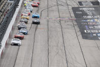 Kyle Larson (5) leads a pack of cars down the front stretch during a NASCAR Cup Series auto race at Darlington Raceway, Sunday, May 8, 2022, in Darlington, S.C. (AP Photo/Matt Kelley)