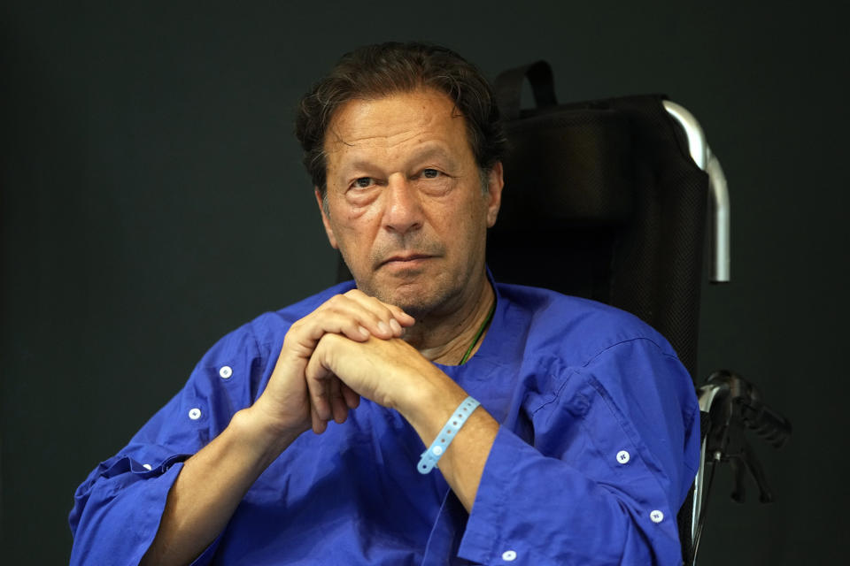 FILE - Former Pakistani Prime Minister Imran Khan speaks during a news conference in Shaukat Khanum hospital, where is being treated for a gunshot wound in Lahore, Pakistan, on Nov. 4, 2022. Pakistani police used water cannons and fired tear gas to disperse supporters of Khan Wednesday, March 8, 2023, in the eastern city of Lahore. Two dozen Khan supporters were arrested for defying a government ban on holding rallies, police said. (AP Photo/K.M. Chaudhry)