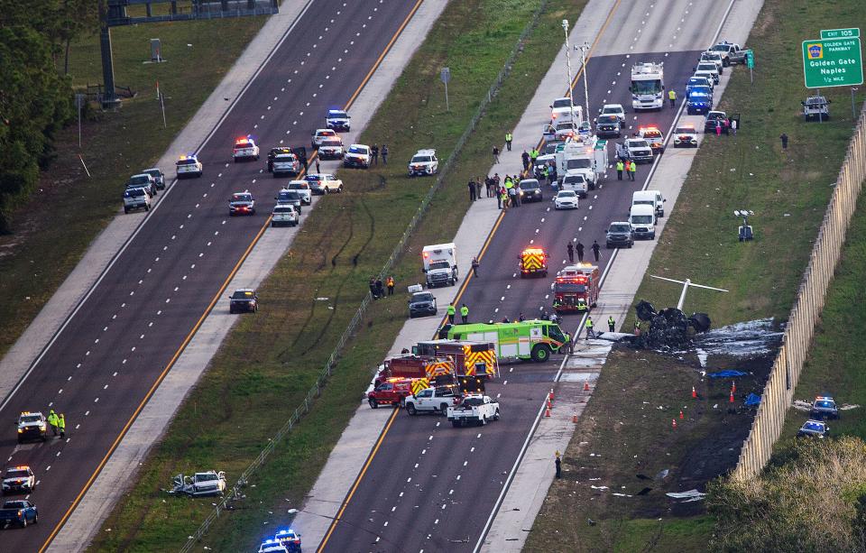 Emergency officials work the scene of plane crash on I-75 in Naples near exit 105 on Friday, Feb. 9, 2024. Two people were confirmed dead.