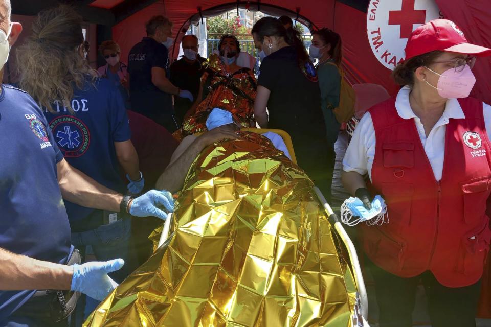 Survivors receive first aid after a rescue operation at the port in Kalamata town, about 240 kilometers (150miles) southwest of Athens on Wednesday, June 14, 2023. Authorities say at least 30 people have died after a fishing boat carrying dozens of migrants capsized and sank off the southern coast of Greece. A large search and rescue operation is underway. Authorities said 104 people have been rescued so far following the incident early Wednesday some 75 kilometers (46 miles) southwest of Greece’s southern Peloponnese region.(www.argolikeseidhseis.gr via AP)