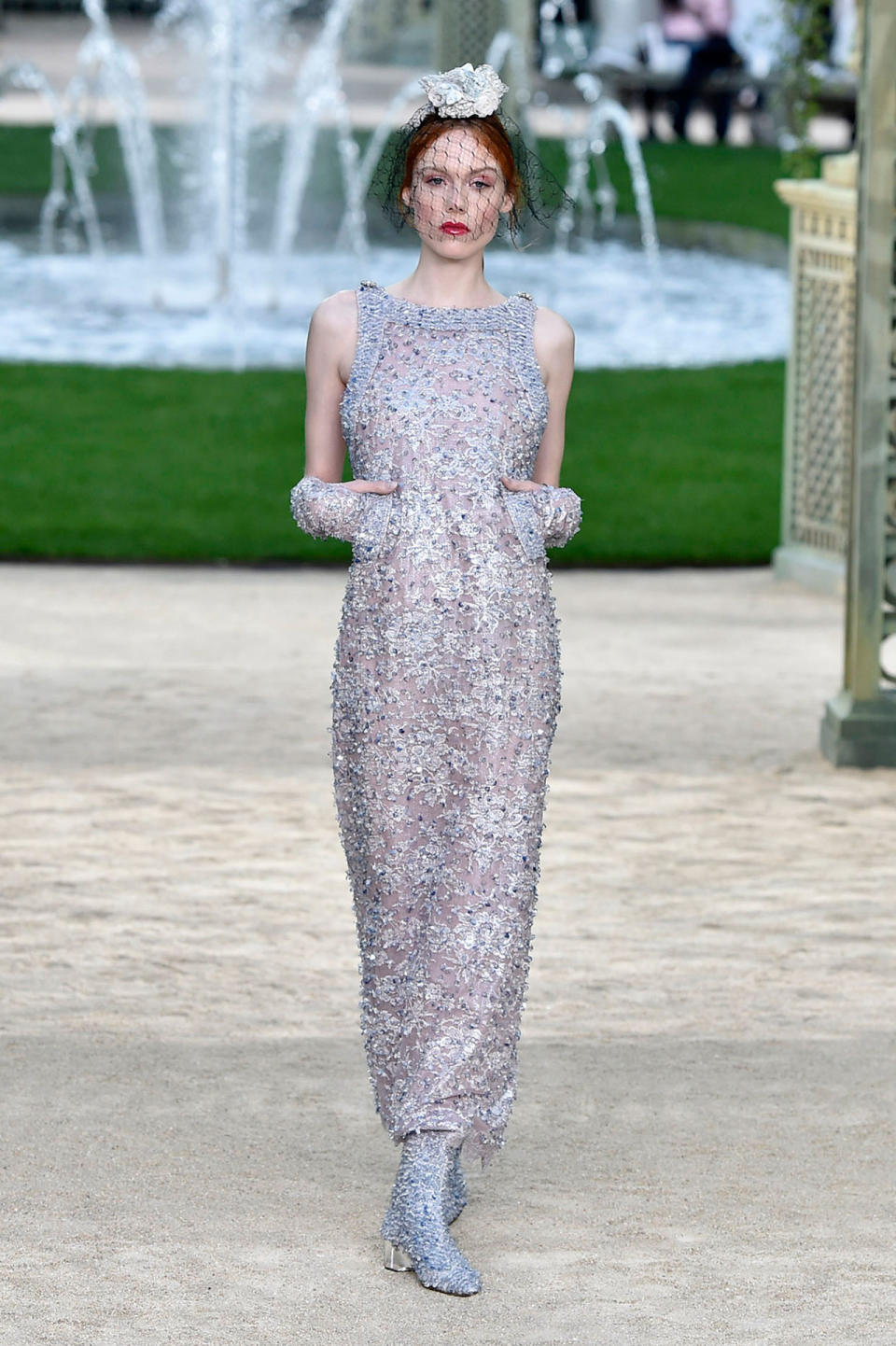 <p>Model wears a long, sleeveless, silver crystal-embellished gown from the Chanel SS18 Haute Couture show. (Photo: Getty Images) </p>