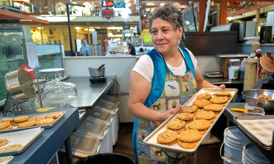 Lily Stockton puts out freshly-baked cookies at Just Cookies, Tuesday, Aug. 29, 2023 in City Market. Stockton has run the business with her husband, Dave Stockton, for 35 years. They are concerned about the state of the market, especially the fact they are on month-to-month lease. City Market is half empty, and vendors are worried about the future.