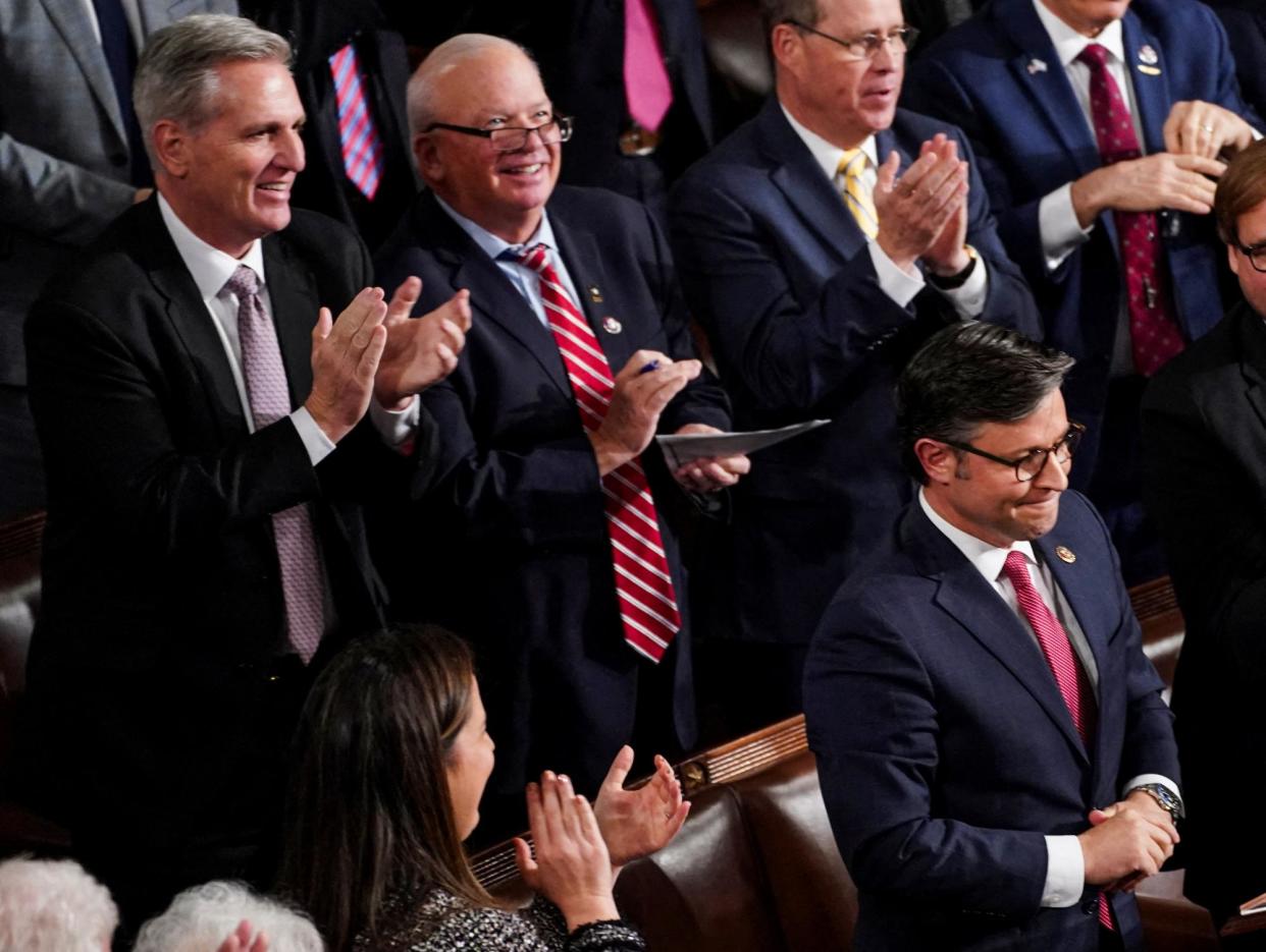 <span>Kevin McCarthy applauds Mike Johnson during another round of voting for House speaker in Washington DC on 25 October 2023.</span><span>Photograph: Nathan Howard/Reuters</span>