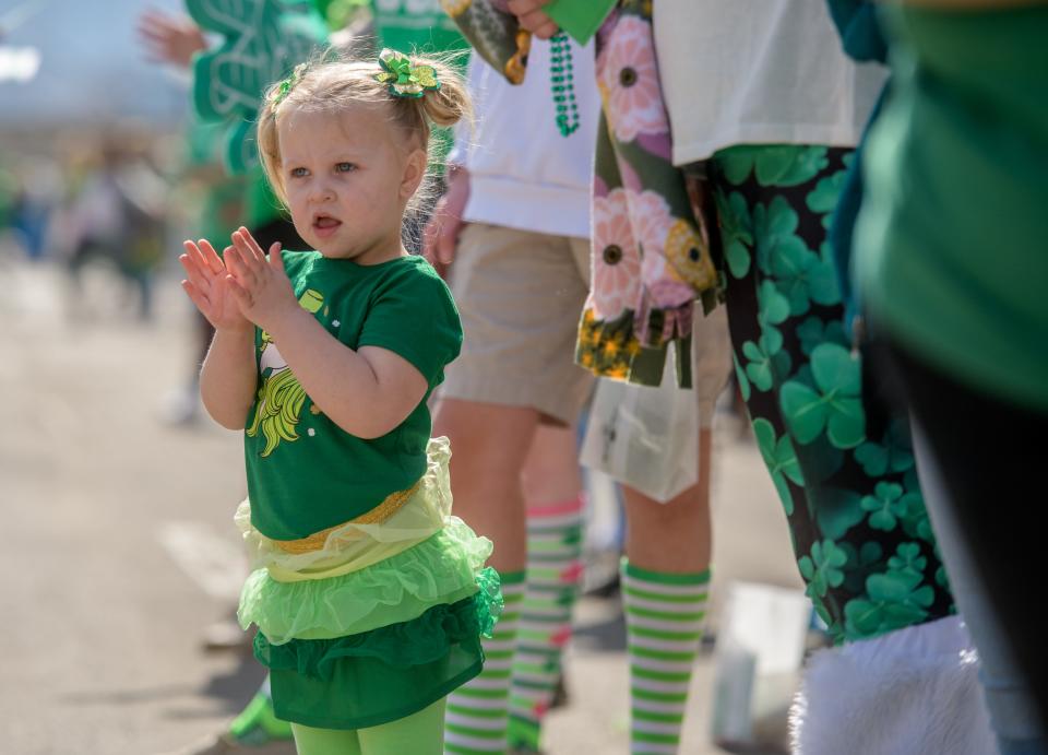 Bedecked in her finest Irish regalia, Aspen Tritsch, 3, of Mapleton claps for the many parade entries in the 2022 St. Patrick's Day Parade on Thursday, March 17, 2022 in downtown Peoria.