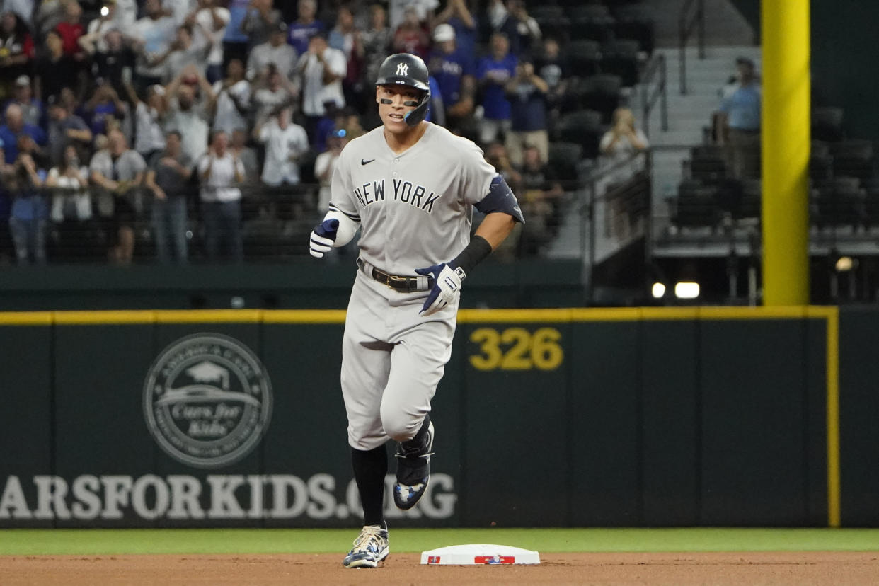 New York Yankees' Aaron Judge rounds the bases after hitting his AL record-breaking 62nd of the season during the first inning against the Texas Rangers in Arlington, Texas, Tuesday, Oct. 4, 2022. (AP Photo/LM Otero)