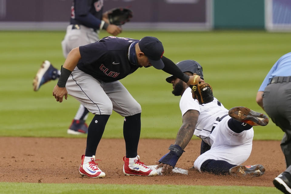 Detroit Tigers' Niko Goodrum safely beats the tag of Cleveland Indians second baseman Cesar Hernandez to steal second during the first inning of a baseball game, Friday, Aug. 14, 2020, in Detroit. (AP Photo/Carlos Osorio)