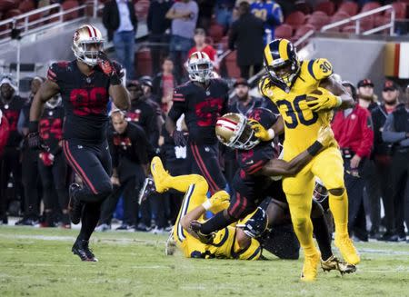 Sep 21, 2017; Santa Clara, CA, USA; Los Angeles Rams running back Todd Gurley (30) carries the ball against San Francisco 49ers cornerback Rashard Robinson (33) during the fourth quarter at Levi's Stadium. Mandatory Credit: Kelley L Cox-USA TODAY Sports