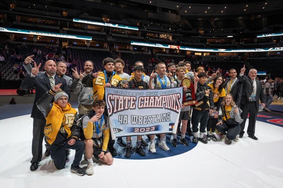 The Pueblo East wrestling team holds its trophy and banner after winning the team Class 4A wrestling championship at Ball Arena on Saturday.