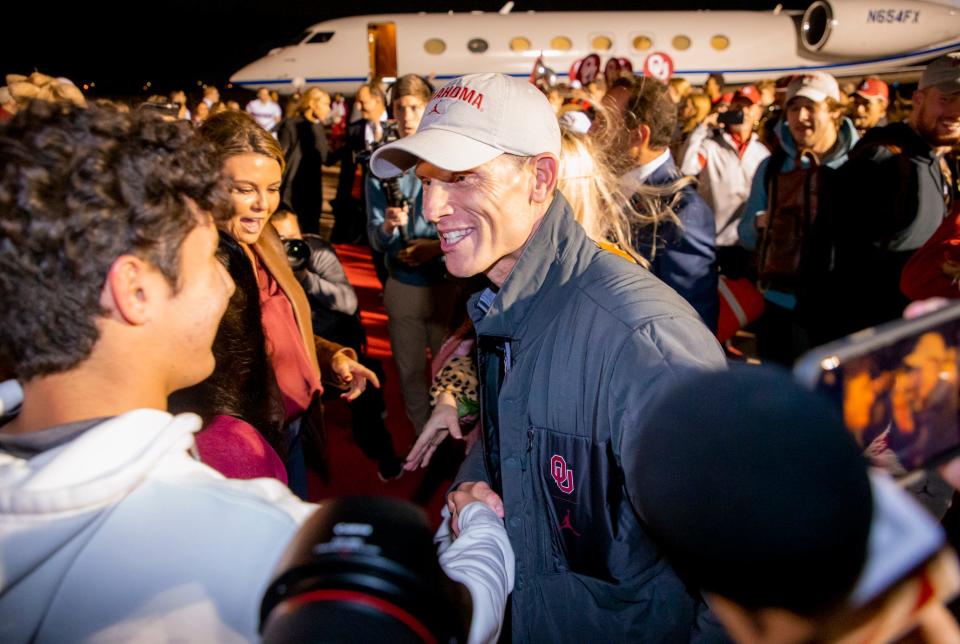 University of Oklahoma's new football coach, Brent Venables, is greeted Sunday night by supporters at Max Westheimer Airport in Norman, Oklahoma.