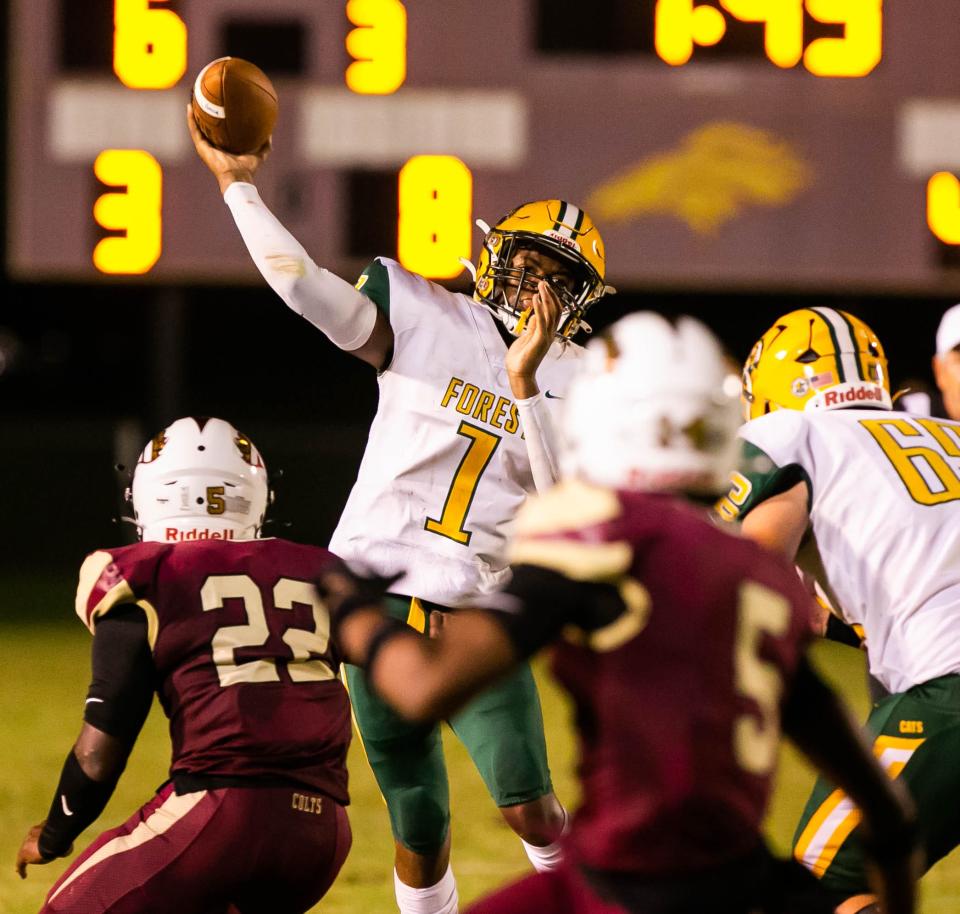 Forest's  Vimel Poole Jr. (1) looks for an open receiver in the first half at North Marion.