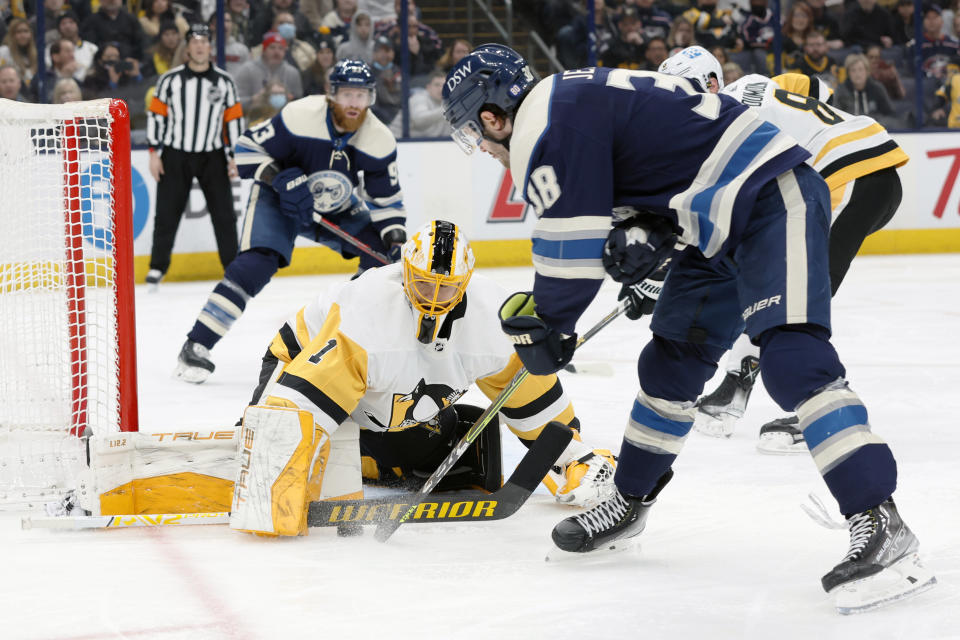 Pittsburgh Penguins' Casey DeSmith, left, makes a save against Columbus Blue Jackets' Boone Jenner during the second period of an NHL hockey game Sunday, Feb. 27, 2022, in Columbus, Ohio. (AP Photo/Jay LaPrete)