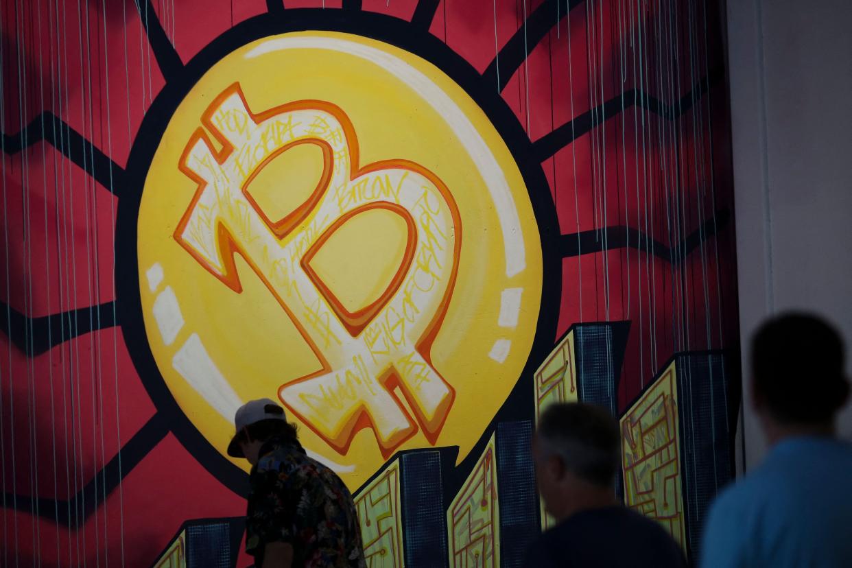 Bitcoin symbol at Bitcoin conference people