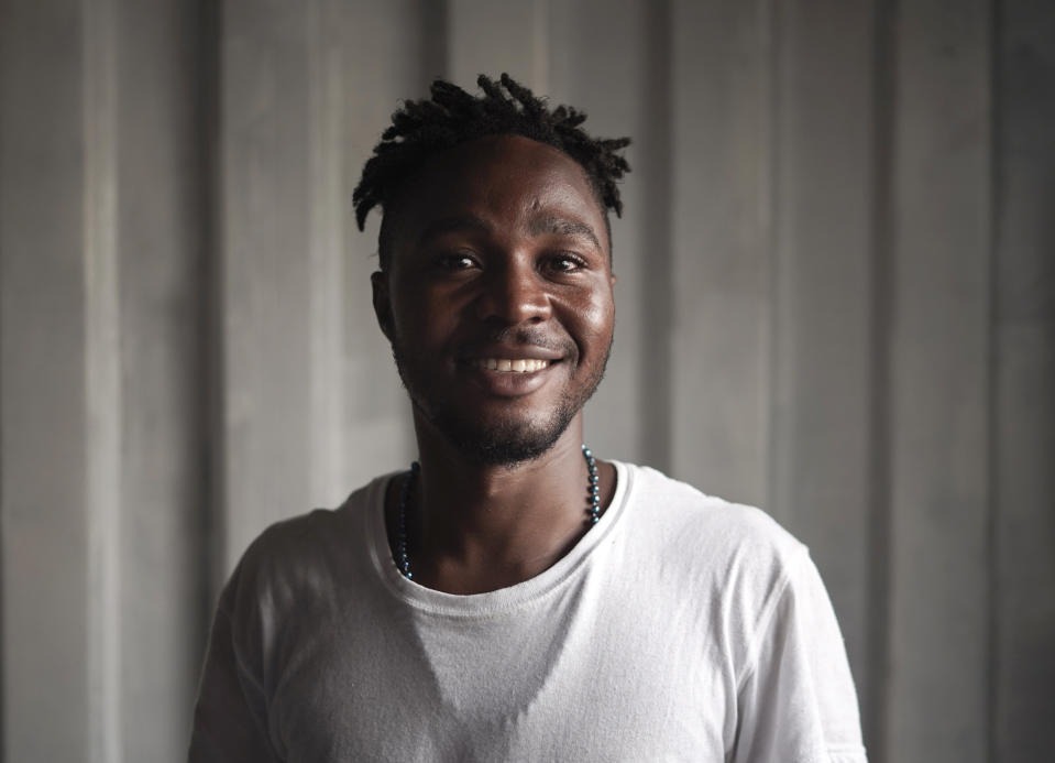 Maro Reele, 22, from Guinea poses for a portrait aboard the humanitarian rescue ship Ocean Viking, in Italian waters off the Sicilian town of Messina, southern Italy, Monday, Sept. 23, 2019, hours before disembarking. Reele traveled alone but often helped the mothers on board, taking care of the little children, playing with them and even carrying them while they took a nap on his shoulders. (AP Photo/Renata Brito)