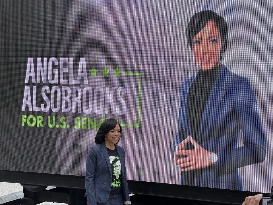 Prince George's County Executive Angela Alsobrooks, a Democratic candidate for United States Senate, stands besides a truck with a digitized screen showing her photograph outside a polling place in Baltimore, Maryland on the primary Election Day, May 14, 2024.