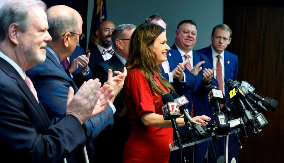 N.C. State Rep. Tricia Cotham, center, is applauded by N.C. House and Senate leaders as she comes to the podium to speak during a press conference Wednesday, April 5, 2023. The press conference was to announce Rep. Cotham is switching parties to become a member of the House Republican caucus.