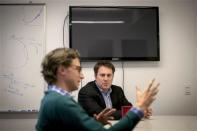 BuzzFeed's Founder and CEO Jonah Peretti (L) speaks as BuzzFeed's Editor-in-Chief Ben Smith looks on, during an interview at the company's headquarters in New York January 9, 2014. BuzzFeed has come a long way from cat lists. REUTERS/Brendan McDermid