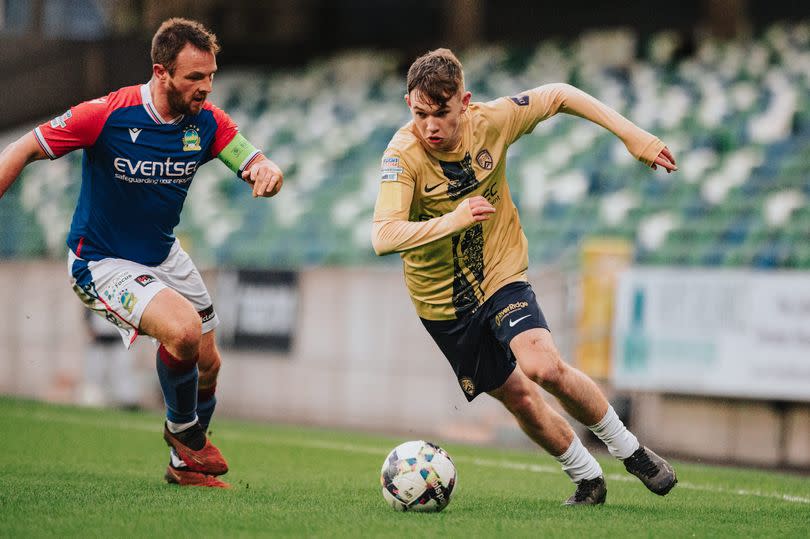 A picture of Coleraine teenager Alfie Gaston battling with Linfield's Jamie Mulgrew