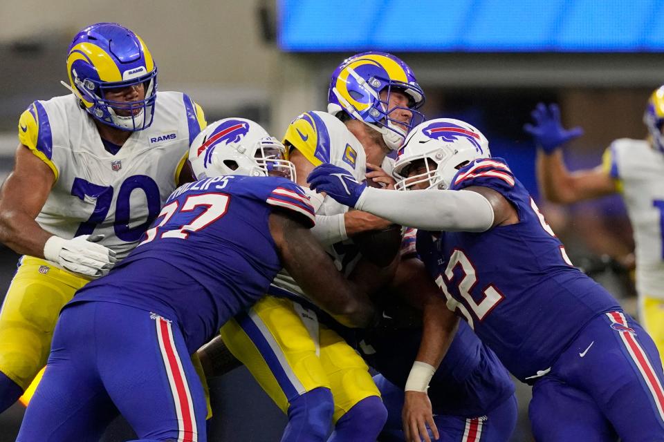 Los Angeles Rams quarterback Matthew Stafford, center, is tackled by Buffalo Bills defensive tackle Jordan Phillips, left, and defensive tackle DaQuan Jones during the first half of an NFL football game Thursday, Sept. 8, 2022, in Inglewood, Calif. (AP Photo/Mark J. Terrill)