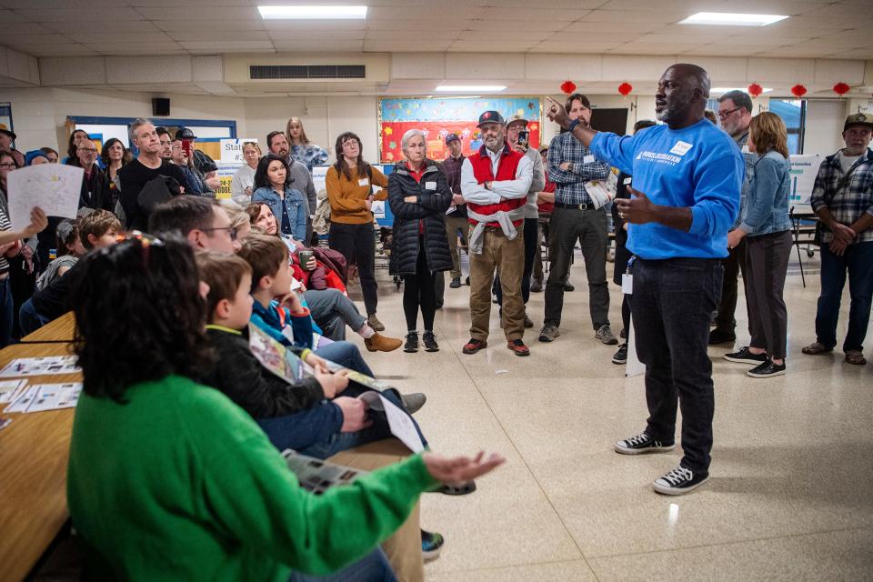 D. Tyrell McGirt, director of Asheville Parks and Recreation, addresses the crowd at the Malvern Hills Pool meeting, February 21, 2024, at Lucy S. Herring Elementary School.
