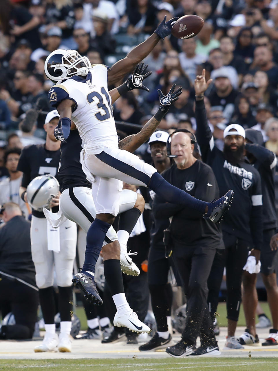 Los Angeles Rams' Darious Williams (31) deflects a pass intended for Oakland Raiders' Keelan Doss during the second half of a preseason NFL football game Saturday, Aug. 10, 2019, in Oakland, Calif. (AP Photo/Rich Pedroncelli)