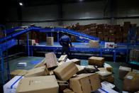 A worker monitors parcels on a conveyor belt at a Hanjin Transportation distribution centre in Gwangju