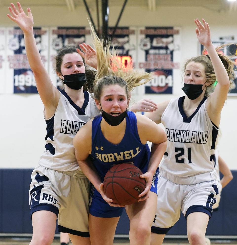 Norwell's Grace Oliver is bracketed by Rockland defenders from left, Sydney Blaney and Maddie Hermenau, during a game on Tuesday, Jan. 25, 2022.