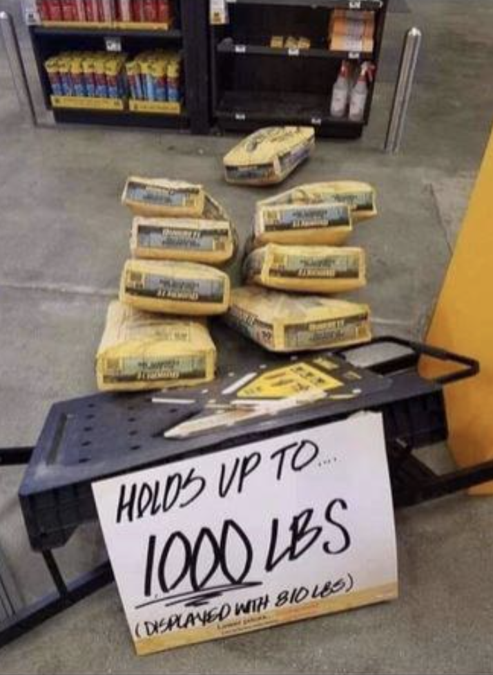 Sign reads "Holds up to 1000 lbs" next to a collapsed table with several bags that were on it