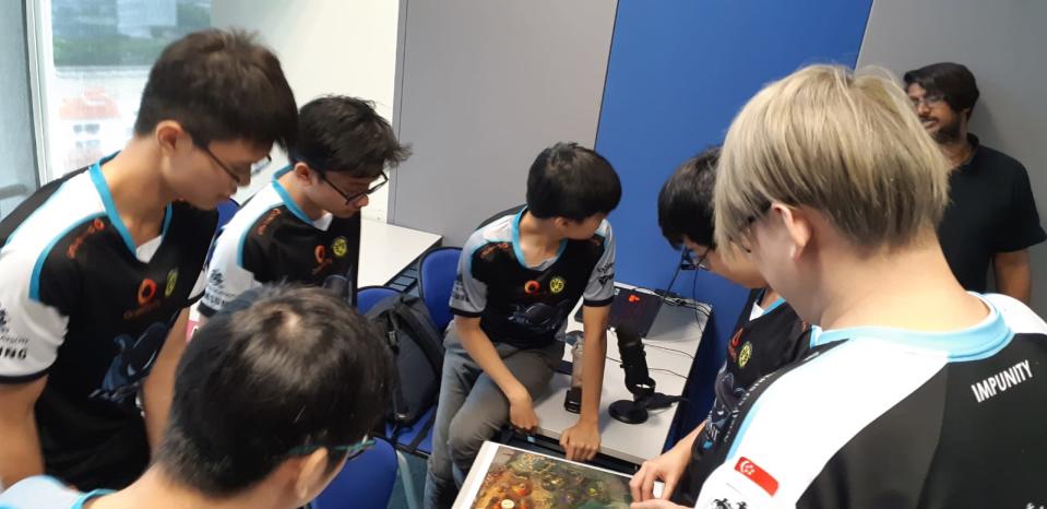 Ker and his teammates discussing strategy. (PHOTO: Yahoo Singapore)