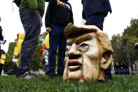 A mask of US President Donald Trump is seen in Parliament Square, as part of a day of action against the US trade deal, ten days before the US Presidential election, in London, Saturday, Oct. 24, 2020. There will will be protests held nationwide against a proposed US trade deal, opposed by a number of organisations including Global Justice Now and Stop Trump Coalition. (AP Photo/Alberto Pezzali)