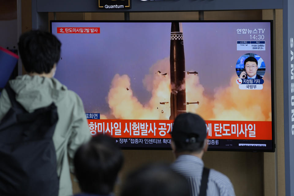 People watch a TV screen showing a news program reporting about North Korea's missiles with file image in Seoul, South Korea, Wednesday, Sept. 15, 2021. North Korea fired two ballistic missiles into waters off its eastern coast Wednesday afternoon, two days after claiming to have tested a newly developed missile in a resumption of its weapons displays after a six-month lull. The letters read "North Korea fired two ballistic missiles." (AP Photo/Lee Jin-man)