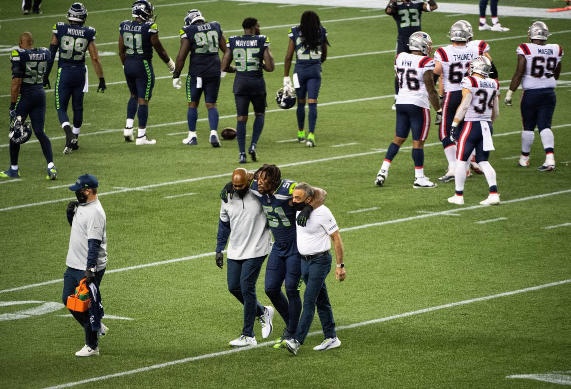 Seattle Seahawks linebacker Bruce Irvin (51) is helped off the field after he injured his leg. The Seattle Seahawks played the New England Patriots in a NFL football game at CenturyLink Field in Seattle, Wash., on Sunday, Sept. 20, 2020.