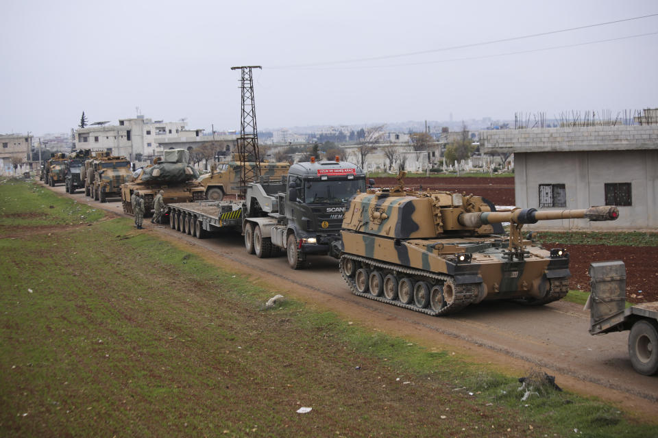 Turkish military convoy is seen near the town of Idlib, Syria, Wednesday, Feb. 12, 2020. Turkish President Recep Tayyip Erdogan said Wednesday that Turkey will attack government forces anywhere in Syria if another Turkish soldier is injured. (AP Photo/Ghaith Alsayed)