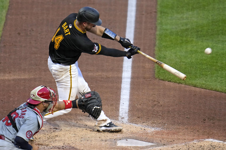 Pittsburgh Pirates' Joey Bart (14) hits a sacrifice fly off off St. Louis Cardinals starting pitcher Miles Mikolas, driving in a run, during the fifth inning of a baseball game in Pittsburgh, Wednesday, July 3, 2024. (AP Photo/Gene J. Puskar)
