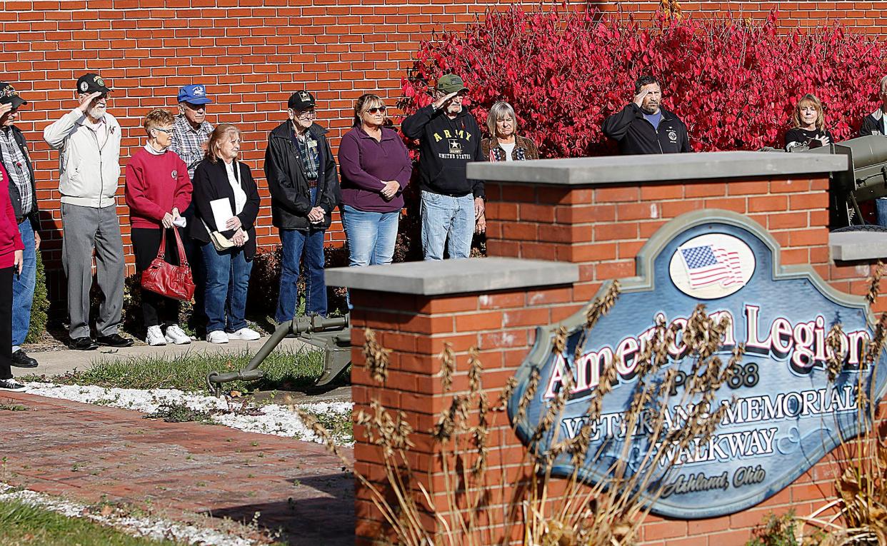 Area Veterans salute during the playing of "Taps" at the Veterans Day program at the Harry Higgins Post 88 of the American Legion on Thursday, Nov. 11, 2021. TOM E. PUSKAR/TIMES-GAZETTE.COM