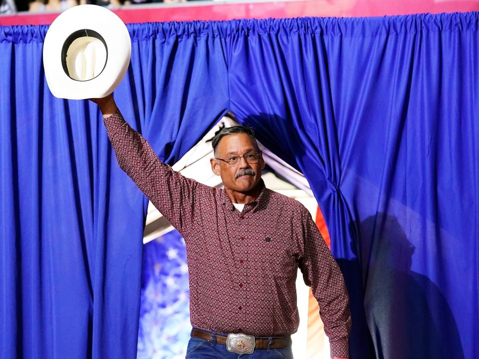 Mark Finchem, a Republican candidate for Arizona Secretary of State, waves to the crowd as he arrives to speak at a Save America rally Friday, July 22, 2022, in Prescott, Ariz.