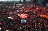 Supporters of various political parties shout slogans and hold Turkish flags and pictures of Ataturk, founder of modern Turkey, in Istanbul's Taksim Square on July 24, 2016