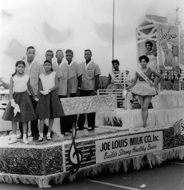 PHOTO: Representatives of the Joe Louis Milk Company ride atop their float, during the annual Bud Billiken Day parade, in Chicago, in 1958.  (Robert Abbott Sengstacke/The Abbott Sengstacke Family Papers via Getty Images)