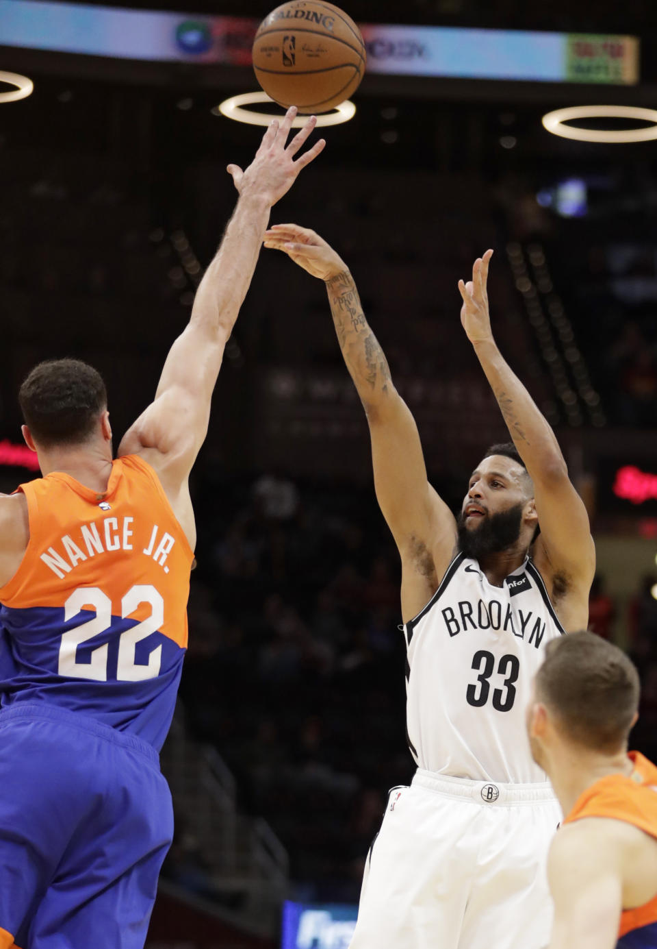 Brooklyn Nets' Allen Crabbe (33) shoots over Cleveland Cavaliers' Larry Nance Jr. (22) in the first half of an NBA basketball game, Wednesday, Feb. 13, 2019, in Cleveland. (AP Photo/Tony Dejak)