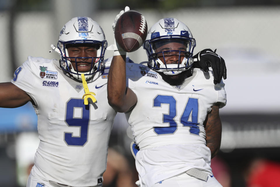 Middle Tennessee linebacker Christian Dixon (34) reacts with defensive end Jordan Ferguson (9) after recovering a fumble against San Diego State during the first half of the Hawaii Bowl NCAA college football game, Saturday, Dec. 24, 2022, in Honolulu. (AP Photo/Marco Garcia)